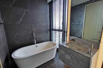 Modern bathroom with freestanding tub and large windows