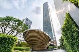 Modern high-rise building with artistic sculpture in the foreground