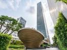 Modern high-rise building with artistic sculpture in the foreground