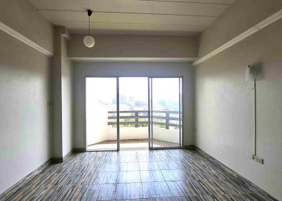 Spacious empty living room with large balcony doors and ample natural light