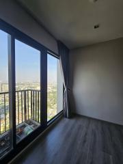 Bright bedroom with large windows and city view