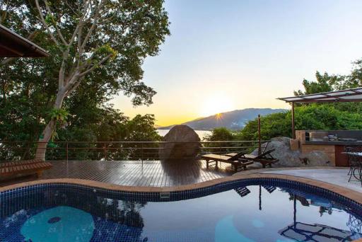 Luxurious outdoor pool area with sunset view and natural surroundings