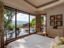 Spacious bedroom with a view of the pool and mountains
