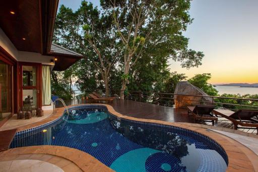 Luxurious outdoor space with a private pool and stunning sunset view
