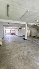 Spacious unfurnished basement area with concrete flooring and exposed beams