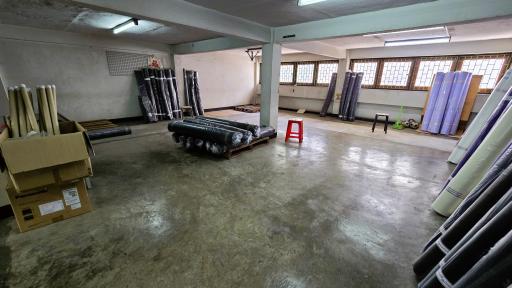 Spacious unfinished basement area with various stored items