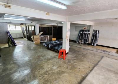 Spacious indoor storage or parking area with concrete flooring