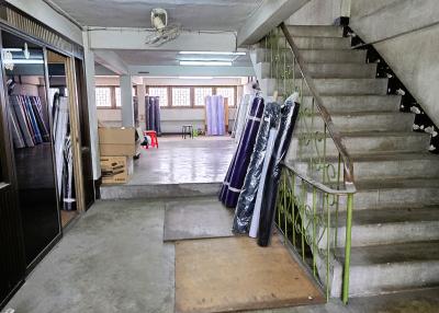 Interior view of a building with staircase and concrete flooring