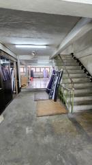 Interior view of a building with staircase and concrete flooring