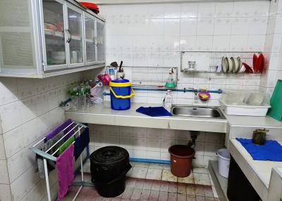 Spacious kitchen with white cabinetry and tiled flooring