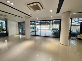 Spacious commercial building interior with large glass windows and glossy tiled flooring