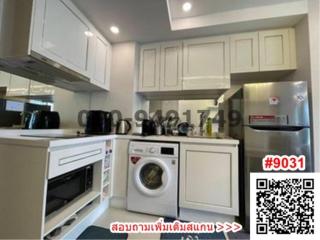 Modern kitchen with white cabinetry and stainless steel appliances