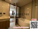 Spacious bathroom with bathtub and glass shower partition