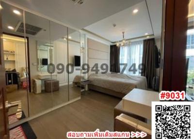 Spacious bedroom with large mirror wardrobe and modern design
