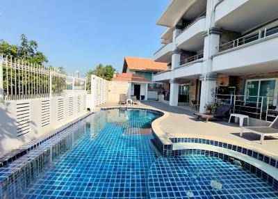 Outdoor pool area with adjacent residential building