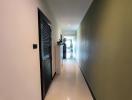 Bright and spacious hallway leading towards the living spaces with tiled flooring and neutral wall colors