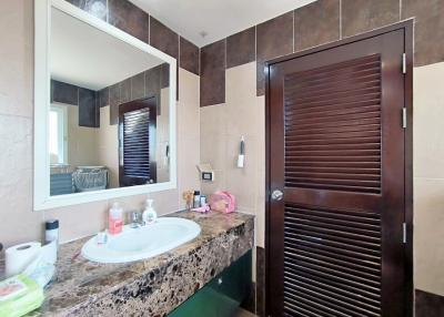 Modern bathroom interior with large mirror and vanity