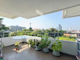 Spacious balcony with city view and potted plants