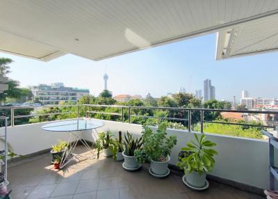 Spacious balcony with city view and potted plants