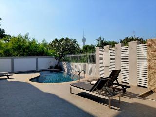 Private pool with lounge chairs and sunny skies