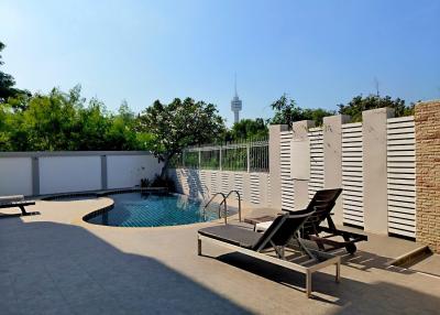 Private pool with lounge chairs and sunny skies