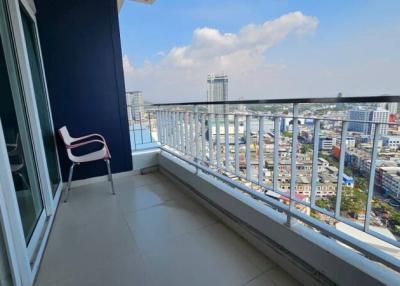 Spacious balcony with city view and seating