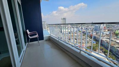 Spacious balcony with city view and seating