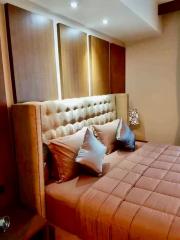 Elegant bedroom with tufted headboard and warm lighting