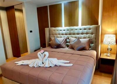 Spacious and well-appointed bedroom with comfortable king-sized bed and modern wooden furniture