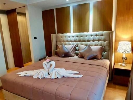 Spacious and well-appointed bedroom with comfortable king-sized bed and modern wooden furniture