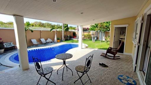 Spacious outdoor patio with swimming pool and garden