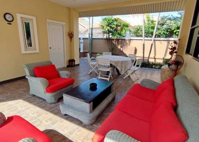 Spacious furnished patio with comfortable seating and dining area