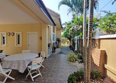 Spacious patio area with outdoor seating and lush greenery