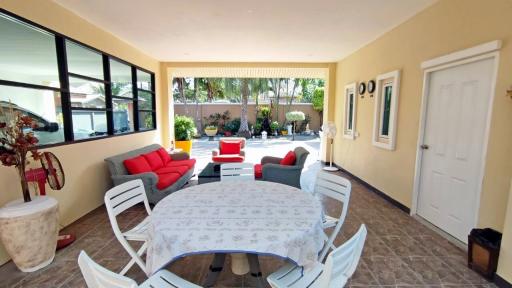 Spacious covered patio with dining area and comfortable seating