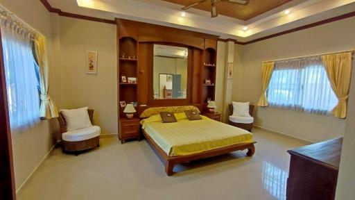 Spacious Bedroom with Wooden Furniture and Attached Bathroom