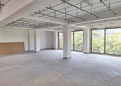 Spacious empty commercial space with large windows and city view