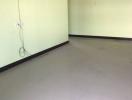 Empty room with green walls and white flooring