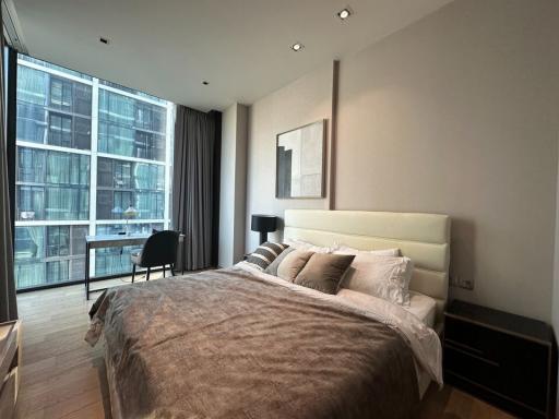 Modern bedroom with large window and city view