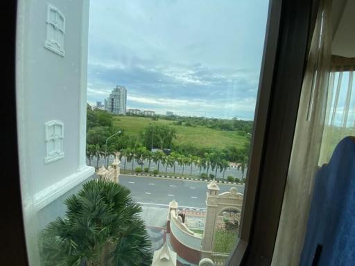 View from building window overlooking green landscape and cityscape