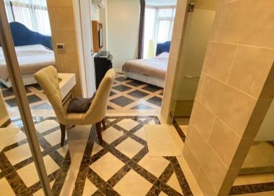 Spacious and modern bedroom with en-suite bathroom and geometric floor tiles