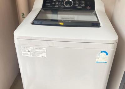 Top-loading washing machine in a small laundry area