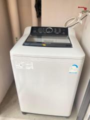 Top-loading washing machine in a small laundry area