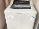 Top-loading washing machine in a small laundry area