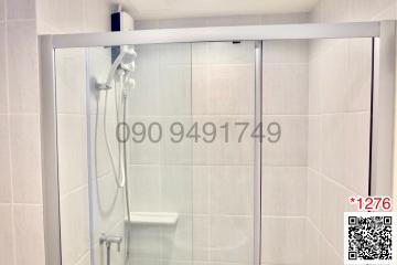 Modern tiled bathroom with glass shower enclosure