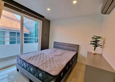 Modern bedroom with king-sized bed and balcony access