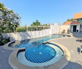 Spacious outdoor area with swimming pool and seating arrangement