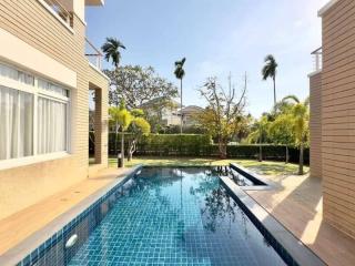 Spacious outdoor area with a private swimming pool and lush garden