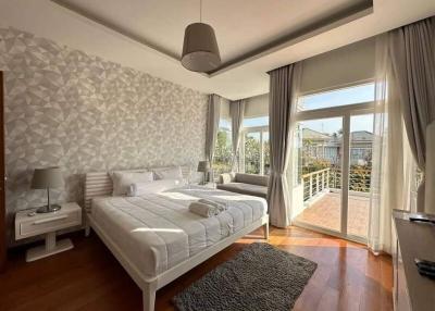 Bright bedroom with large windows and balcony access