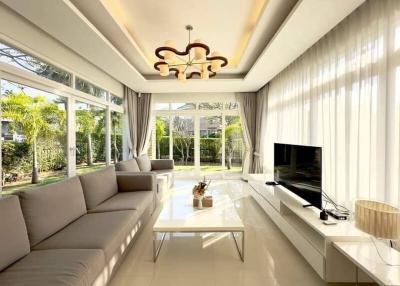 Spacious and sunlit living room with modern furniture and garden view