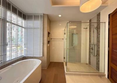 Modern bathroom with separate bathtub and glass-enclosed shower